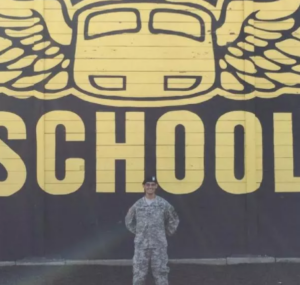 Army cadet in front of the Air Assault school