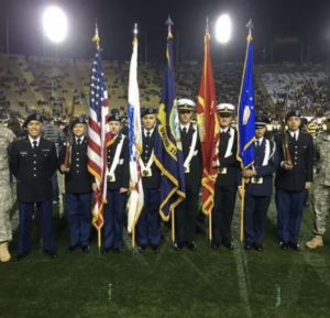 Army Color Guard with five flags on football field